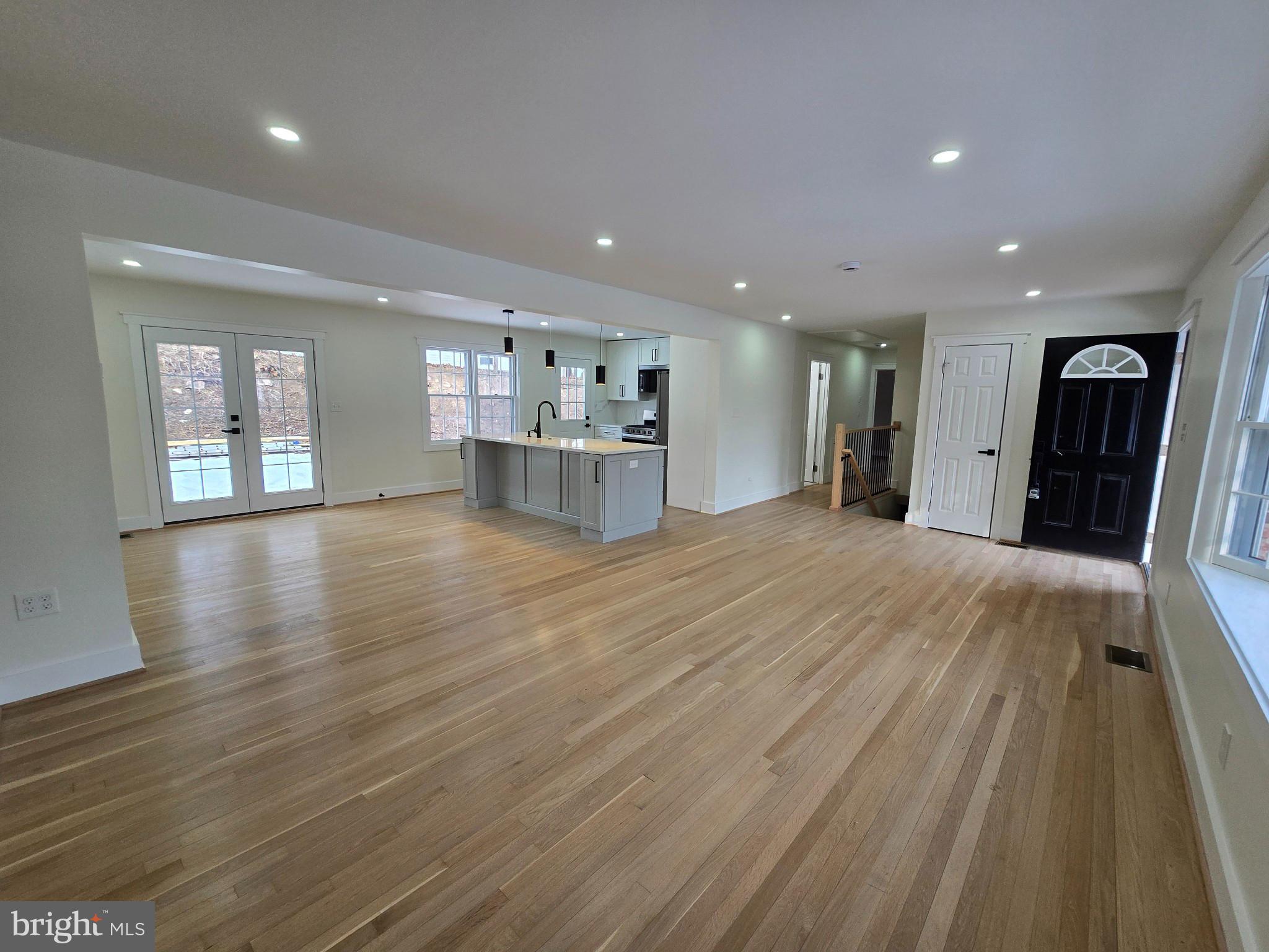 1014 Nora Drive Silver Spring, MD 20904 - Photo 5 of 23 a view of a living room a kitchen with a sink and dishwasher with wooden floor