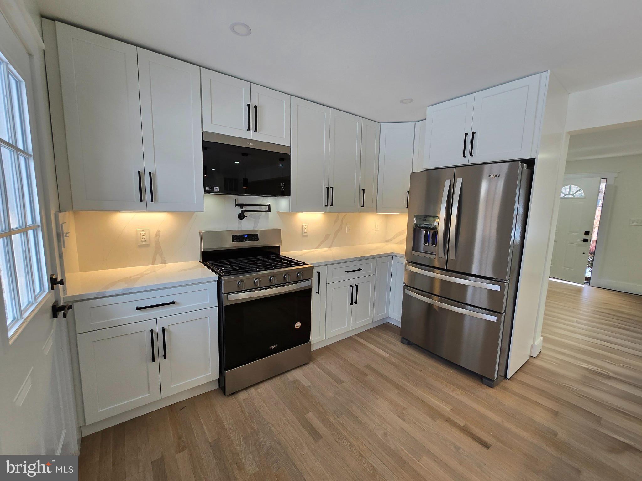 1014 Nora Drive Silver Spring, MD 20904 - Photo 7 of 23 a kitchen with stainless steel appliances a refrigerator sink and microwave