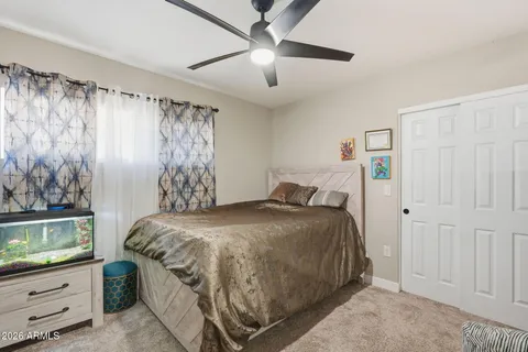a bedroom with a bed and a dresser