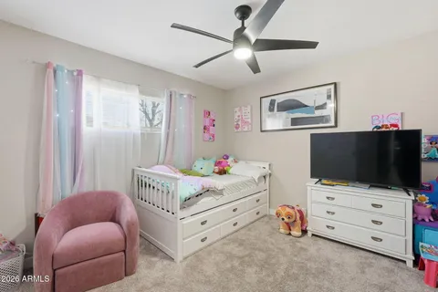 a bedroom with furniture and a flat screen tv
