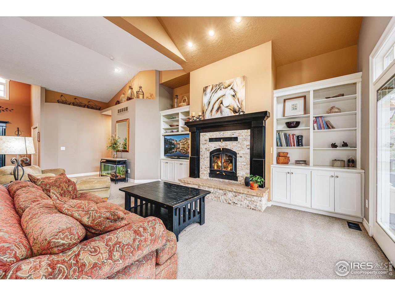 1105 Wyndham Hill Road Fort Collins, CO 80525 - Photo 11 of 40 Living Room w/ Vaulted Ceilings and Built-In Shelving