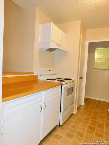 a view of a kitchen with wooden floor and electronic appliances