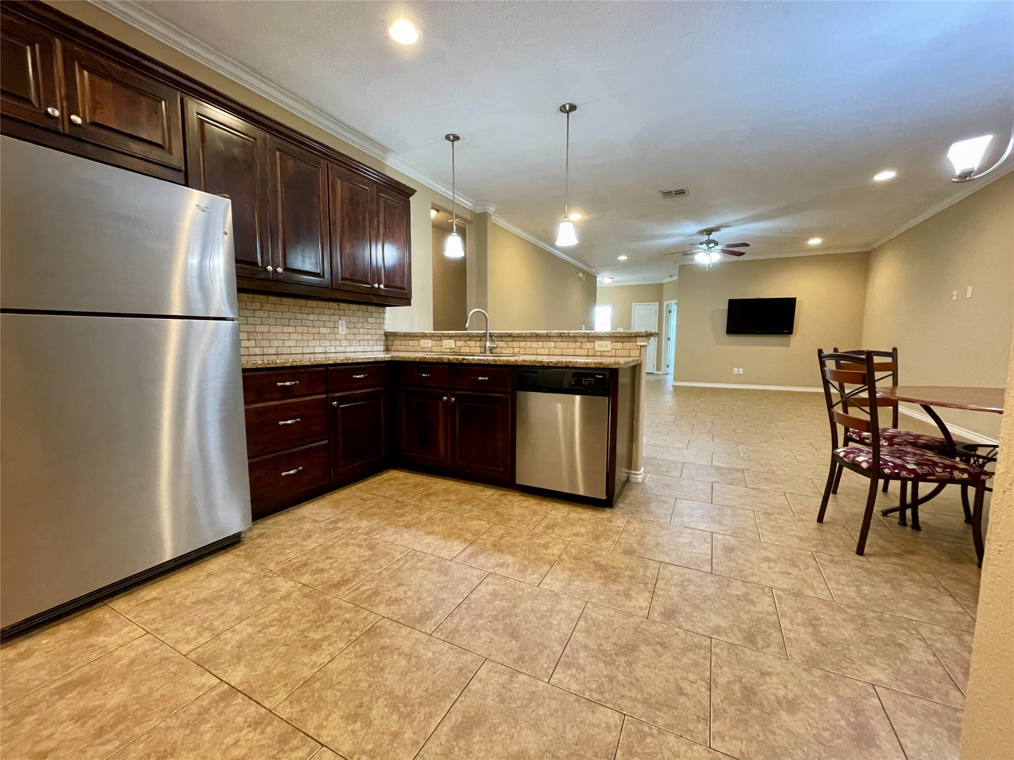 3519 Haverford Road College Station, TX 77845 - Photo 5 of 15 a large kitchen with cabinets chairs and refrigerator