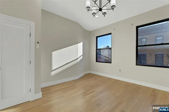 a view of a room with wooden floor and ceiling fan