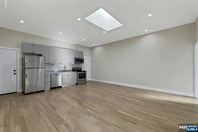 a bathroom with a sink toilet vanity and shower