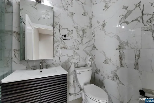 a view of kitchen with stainless steel appliances wooden floor and electronic appliances