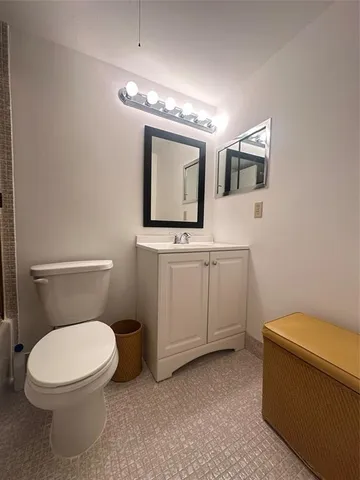 a bathroom with a sink a toilet and mirror
