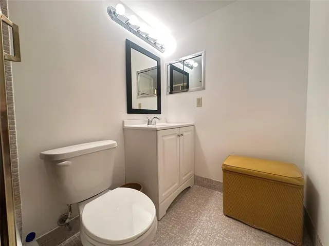 a bathroom with a toilet and a shower