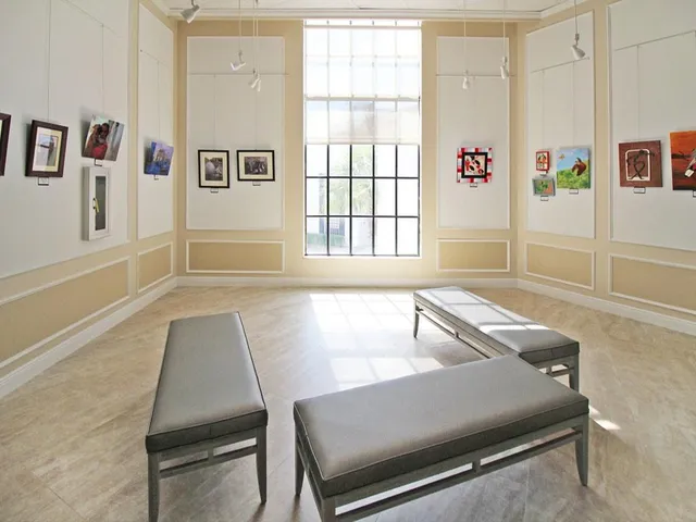 a living room with furniture and large windows