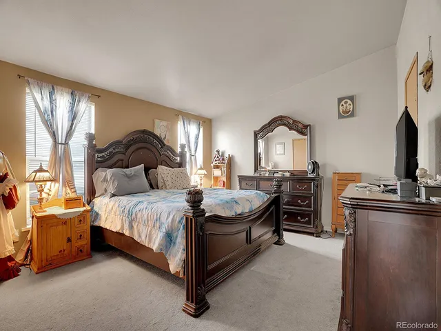 a bathroom with a granite countertop sink a toilet and a mirror