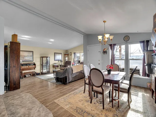 a living room with furniture a fireplace and a chandelier