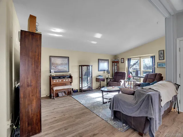 a living room with a couch bookshelf and a window
