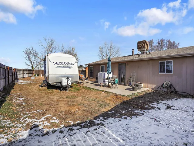 a white house with a large tree in front of it