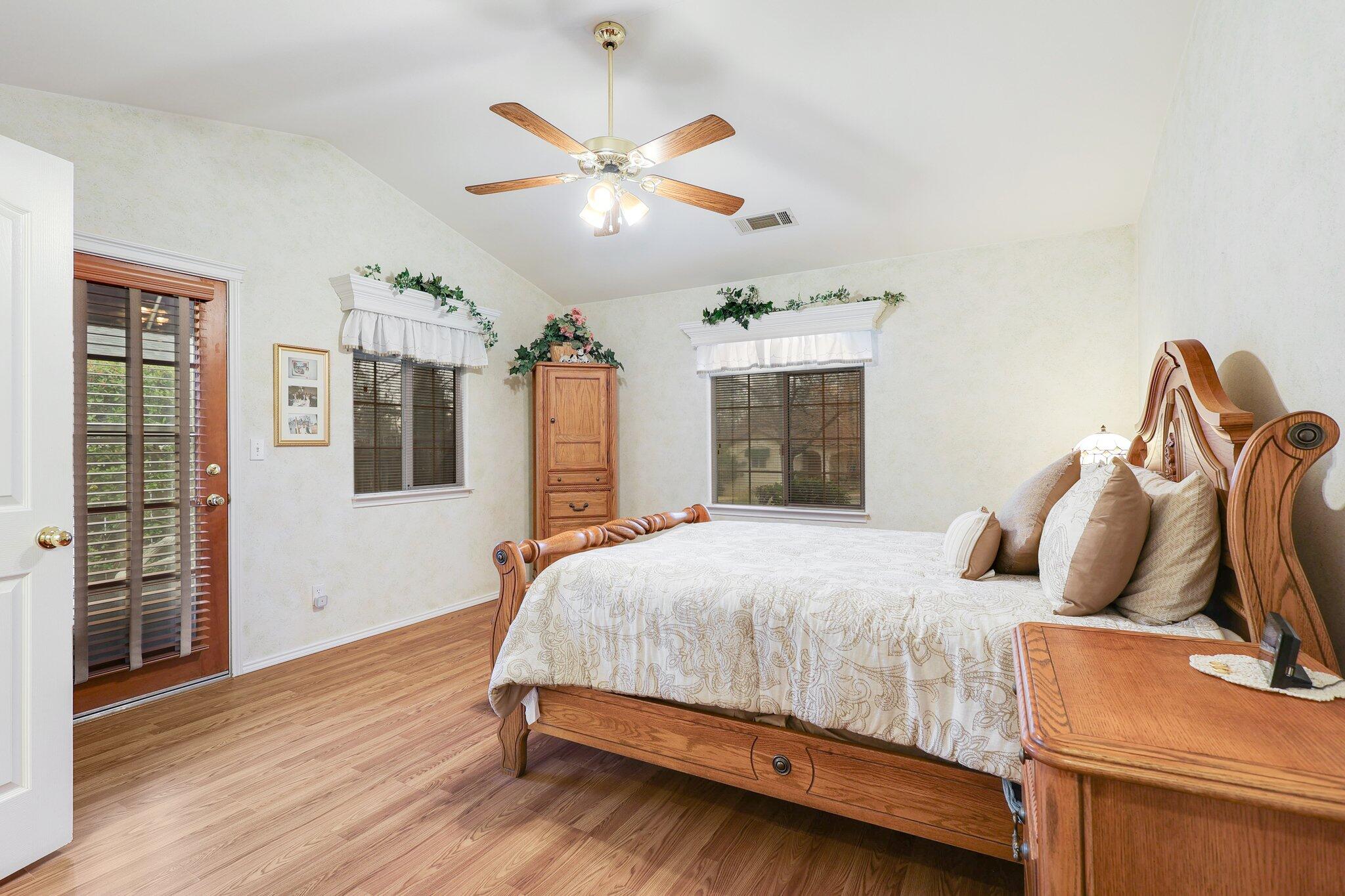19271 Lexington Lane Redding, CA 96003 - Photo 20 of 39 a bedroom with a bed and wooden floor