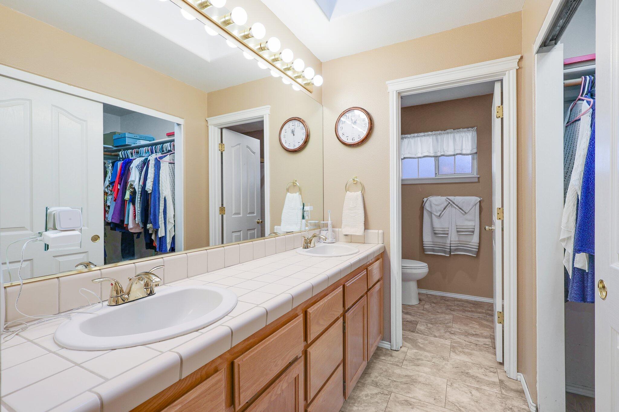 19271 Lexington Lane Redding, CA 96003 - Photo 22 of 39 a spacious bathroom with a granite countertop sink and a mirror