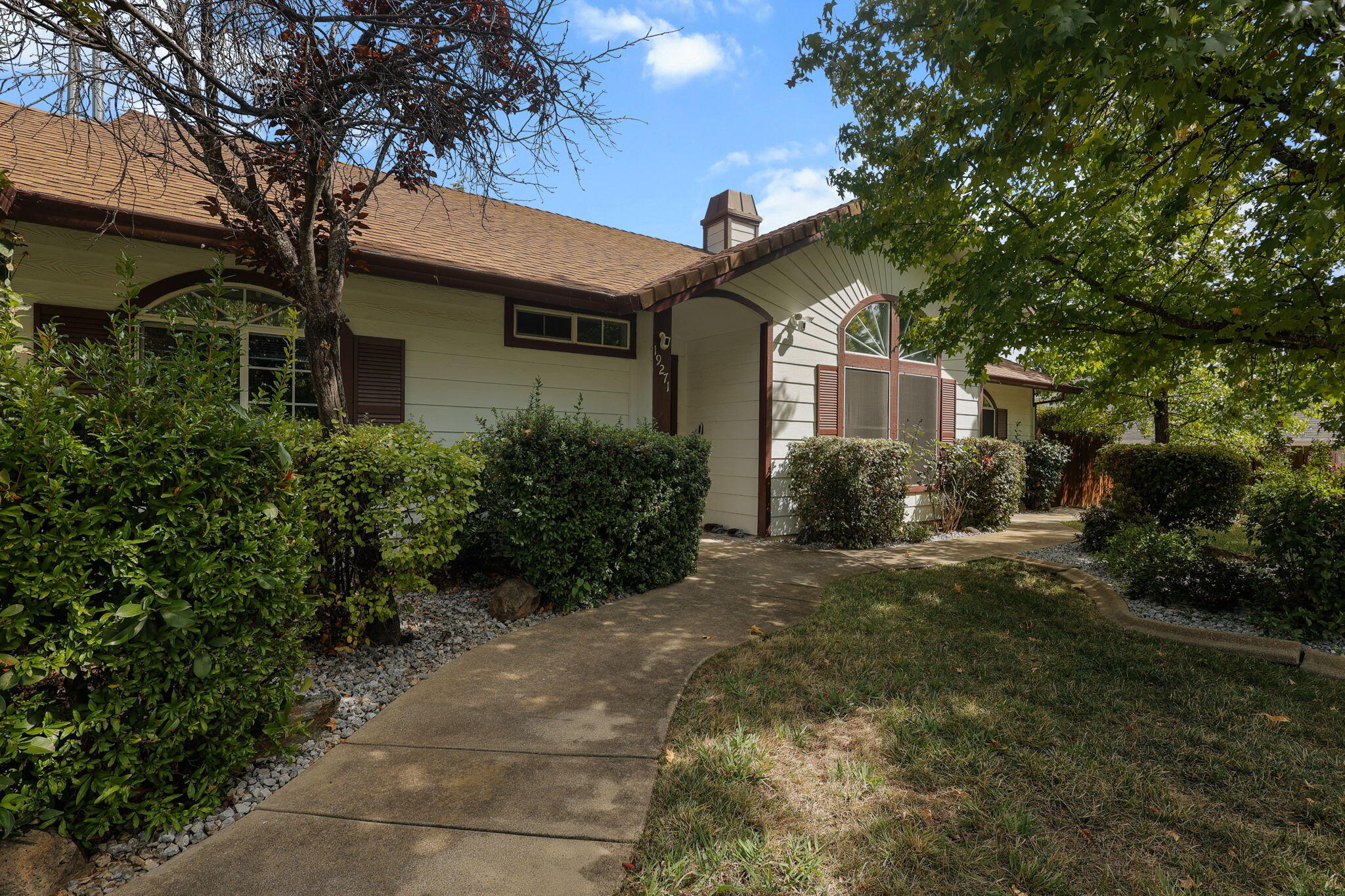 19271 Lexington Lane Redding, CA 96003 - Photo 5 of 39 a front view of a house with garden