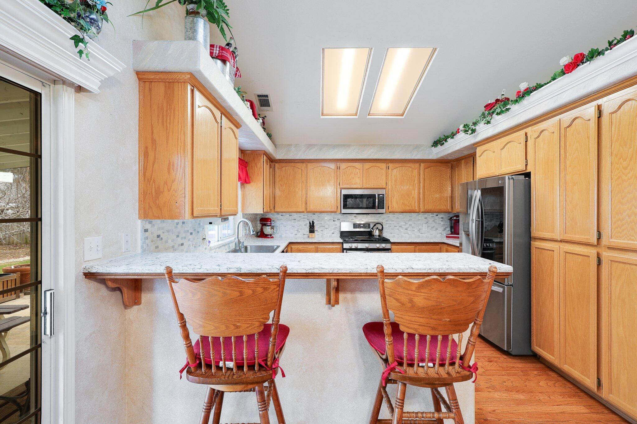 19271 Lexington Lane Redding, CA 96003 - Photo 10 of 39 a kitchen with a table chairs refrigerator and cabinets