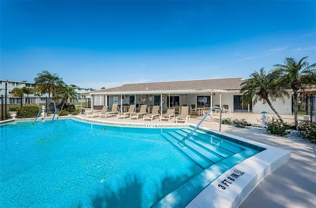 a view of house with swimming pool having outdoor seating
