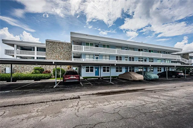 a front view of building with cars parked