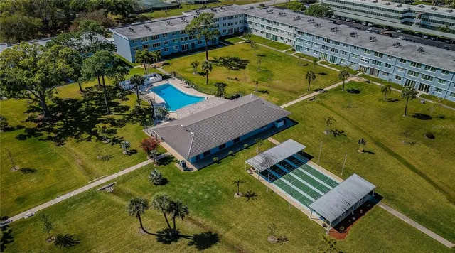 an aerial view of a house with a garden and swimming pool