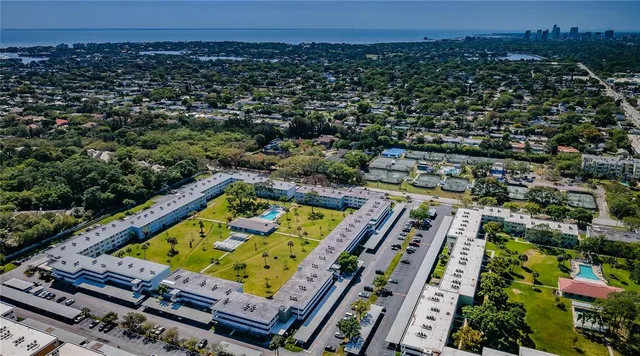 an aerial view of a tennis ground and a large pool
