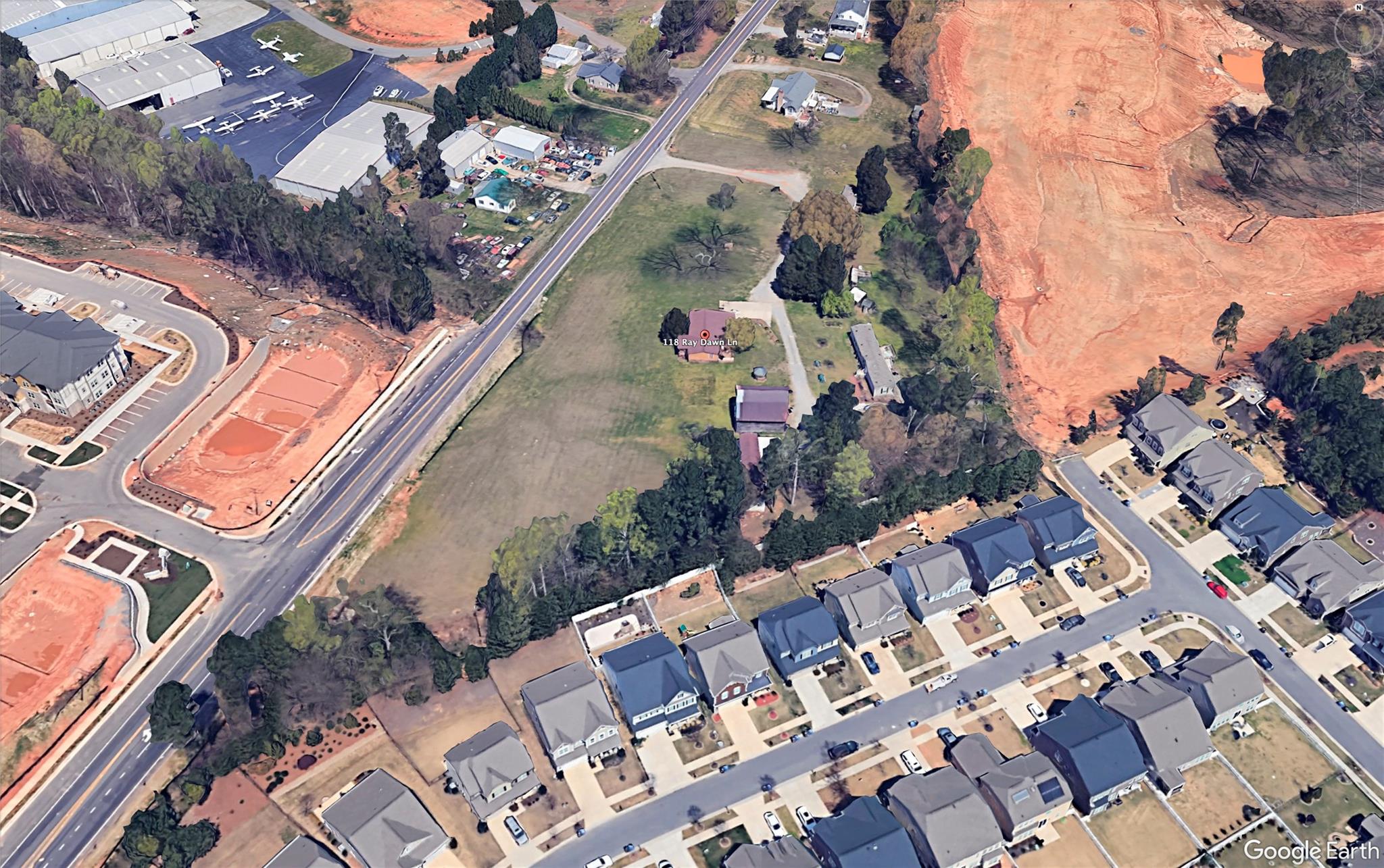 an aerial view of multiple houses with yard