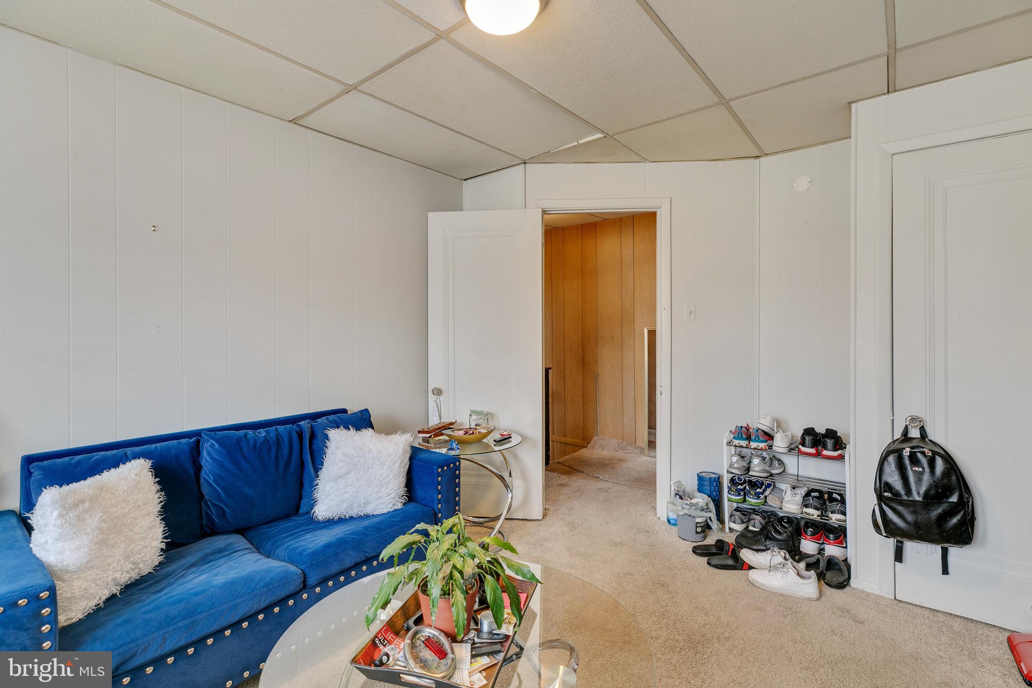 242 Kingston Road Upper Darby, PA 19082 - Photo 13 of 27 a living room with furniture a couch and gym equipment