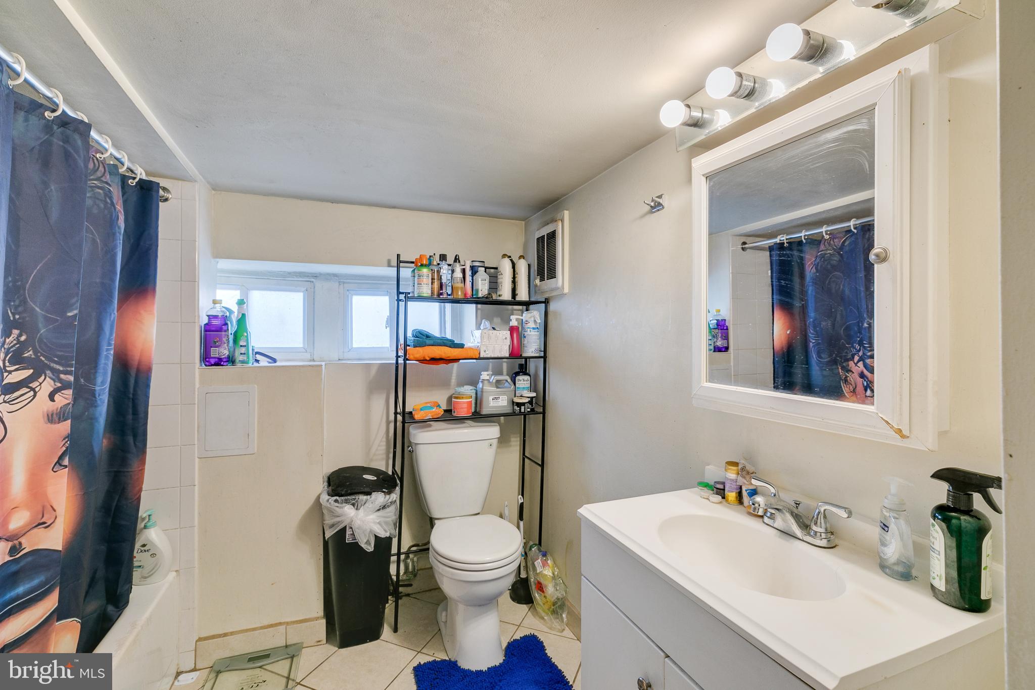 242 Kingston Road Upper Darby, PA 19082 - Photo 25 of 27 a bathroom with a sink a toilet and a mirror