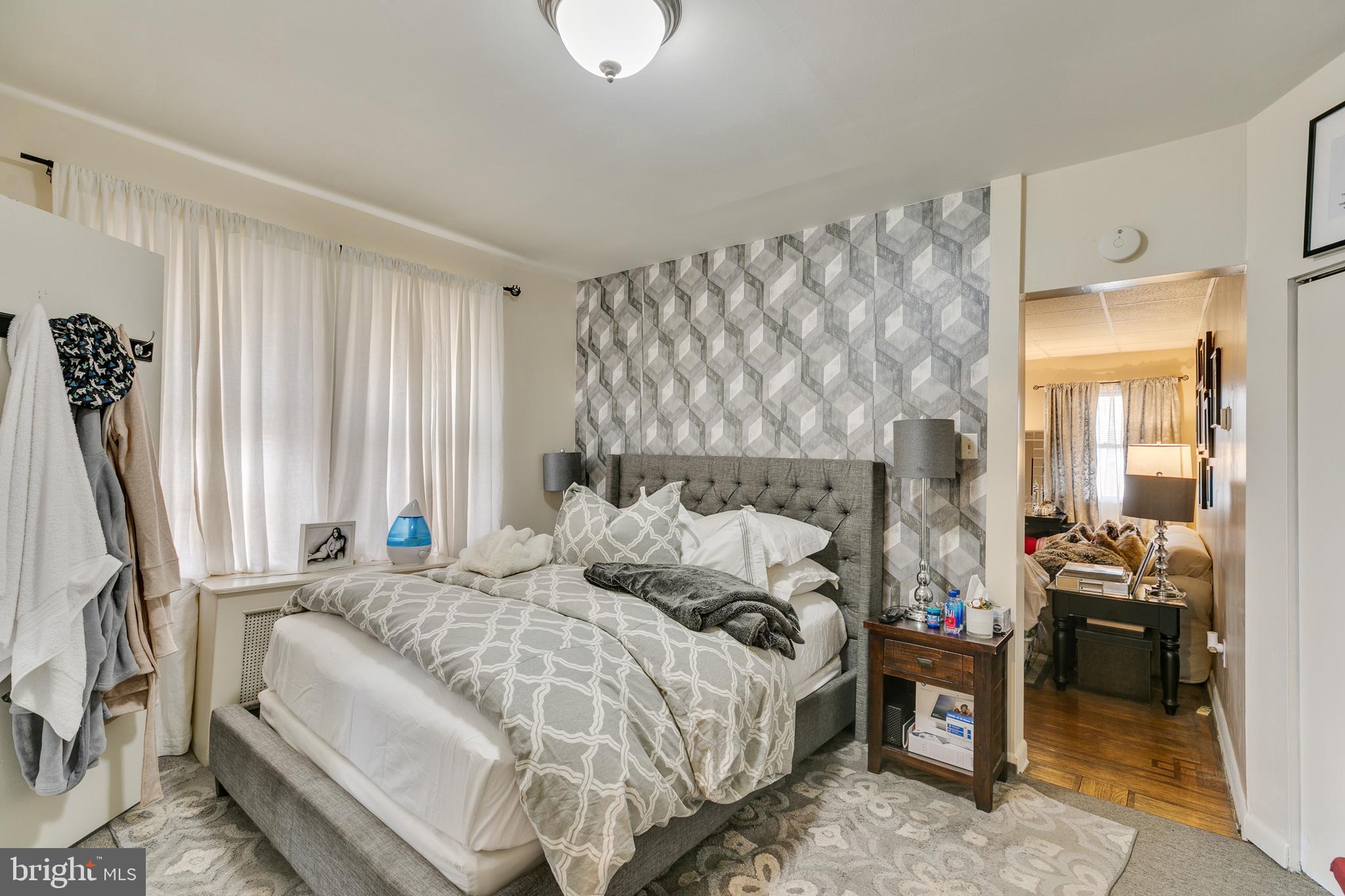 242 Kingston Road Upper Darby, PA 19082 - Photo 4 of 27 a bed sitting in a bedroom next to a window