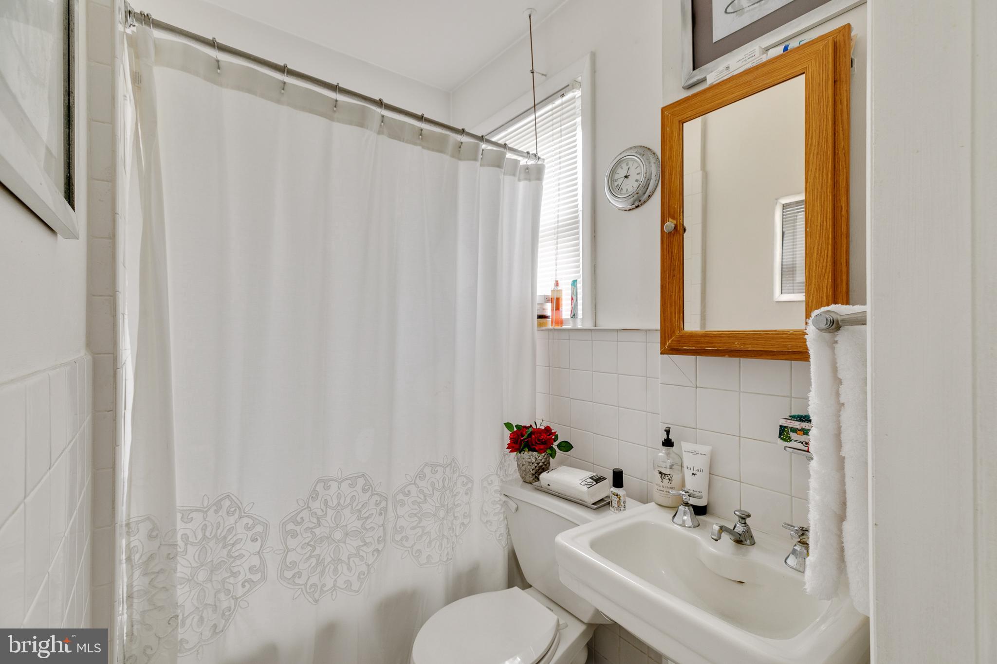 242 Kingston Road Upper Darby, PA 19082 - Photo 6 of 27 a bathroom with a sink and a mirror