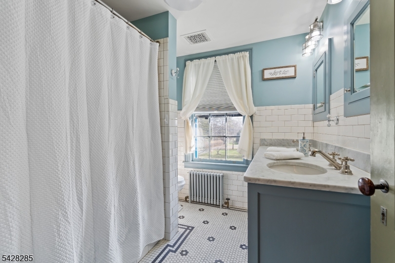 269 Quakertown Road Pittstown, NJ 08867 - Photo 21 of 25 a bathroom with a sink a mirror and a shower curtain