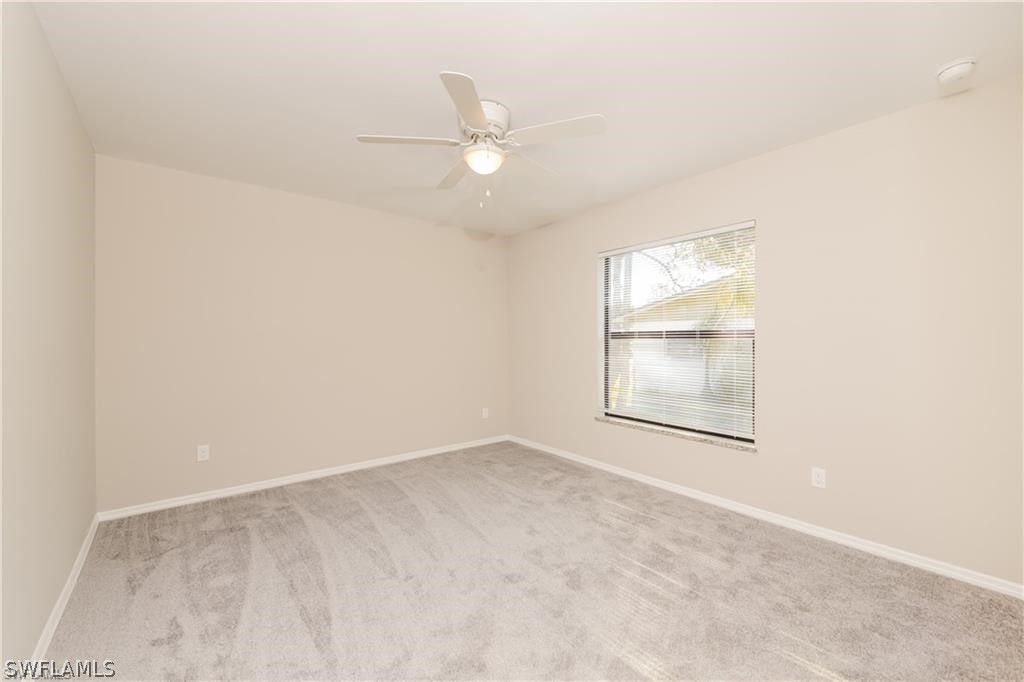 8422 Cardinal Road Fort Myers, FL 33967 - Photo 14 of 15 an empty room with a window and ceiling fan