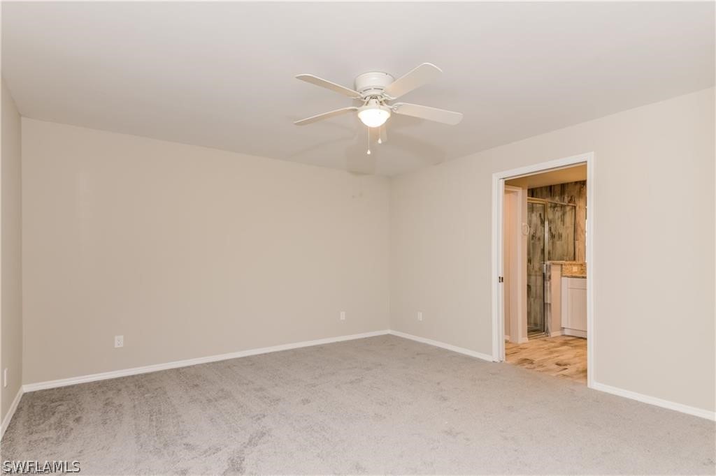 8422 Cardinal Road Fort Myers, FL 33967 - Photo 7 of 15 an empty room with closet and a ceiling fan