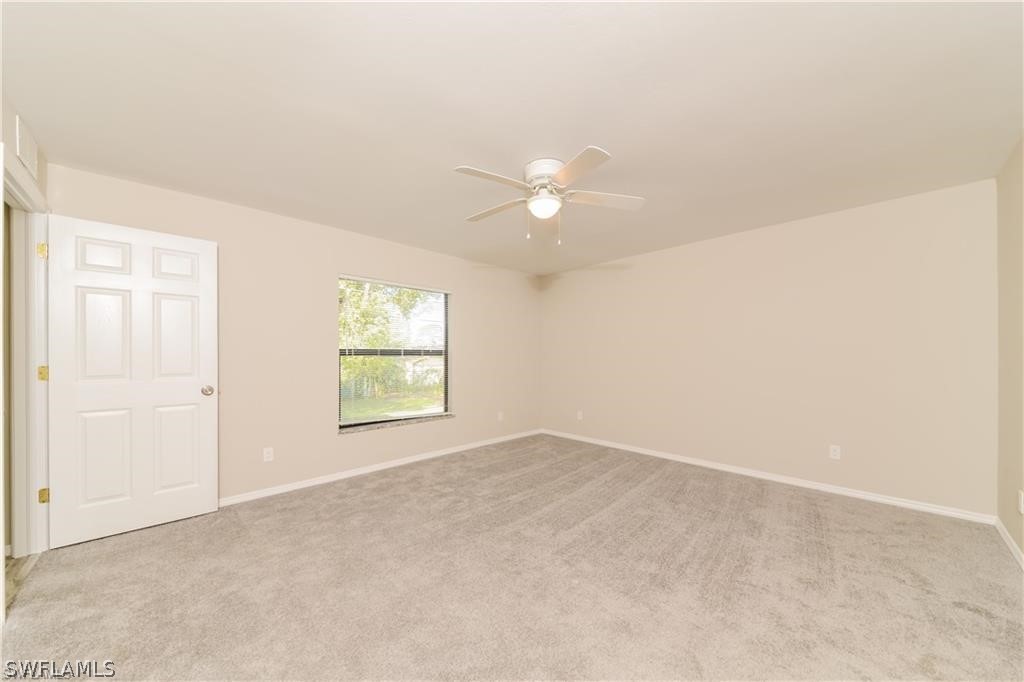 8422 Cardinal Road Fort Myers, FL 33967 - Photo 8 of 15 an empty room with windows and fan