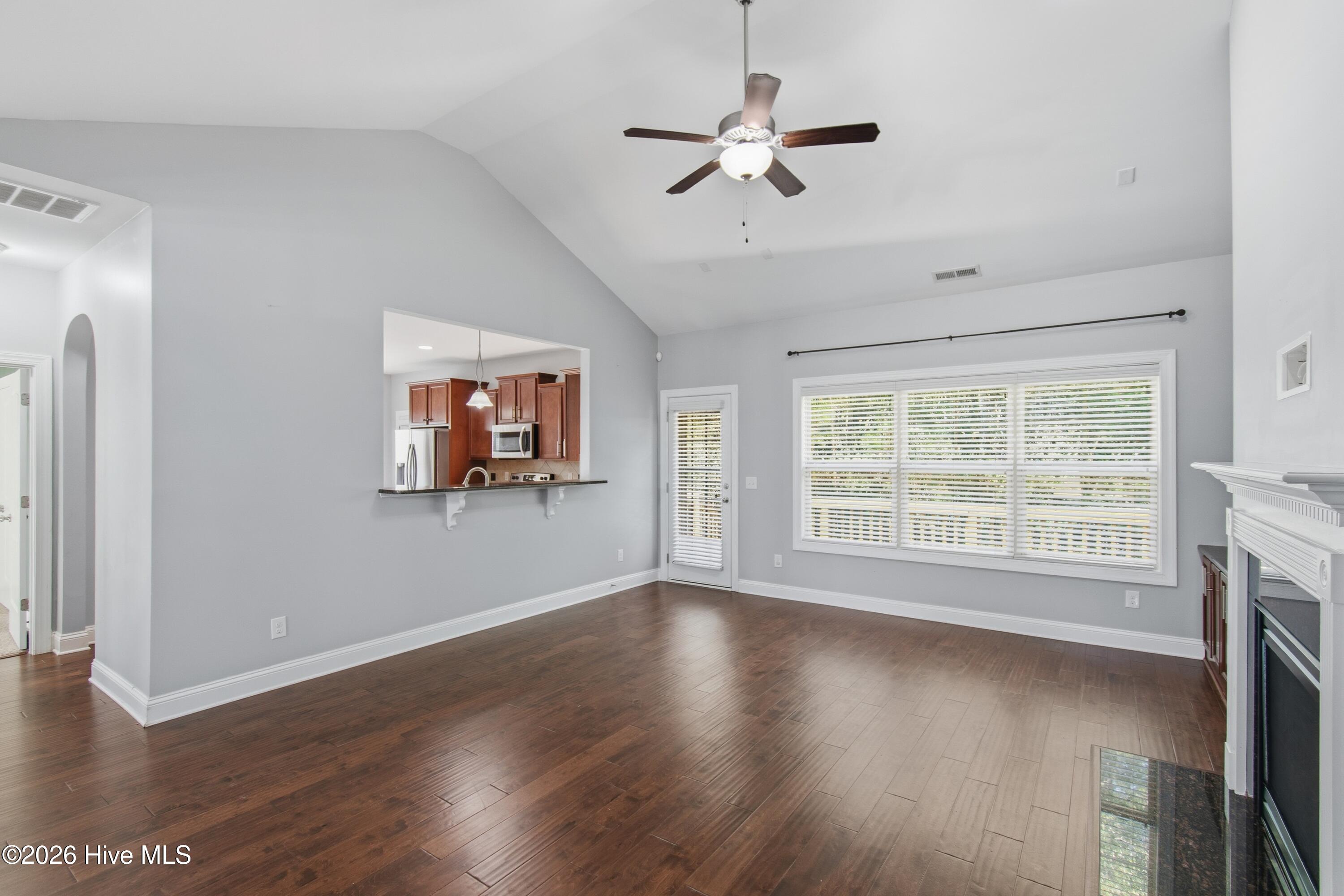 1678 Old Salt Run Southwest Shallotte, NC 28470 - Photo 12 of 73 Living room with peek thru window into kitchen. High ceilings create an airy feel.