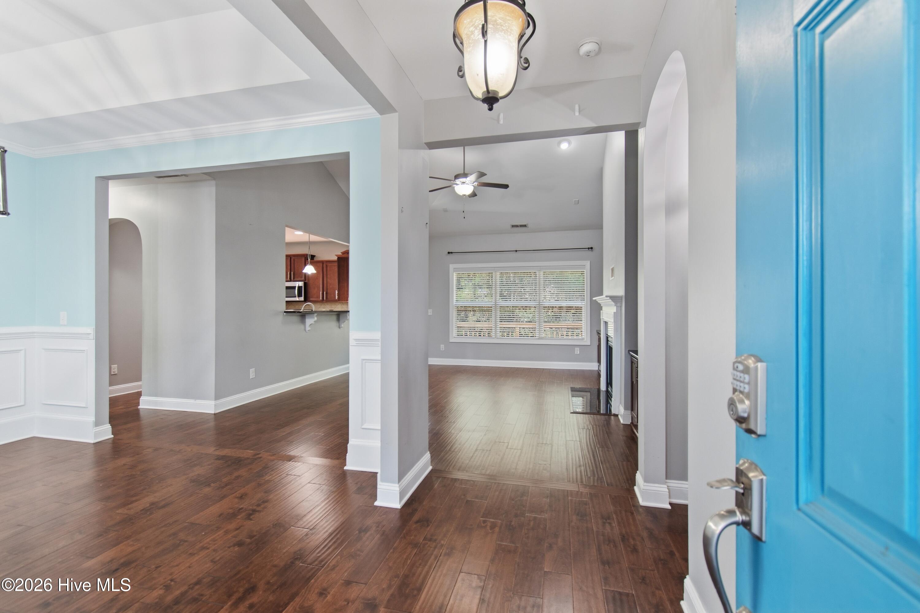 1678 Old Salt Run Southwest Shallotte, NC 28470 - Photo 9 of 73 Front entrance, dining room to the left and living room straight ahead. Dark stained wood flooring.