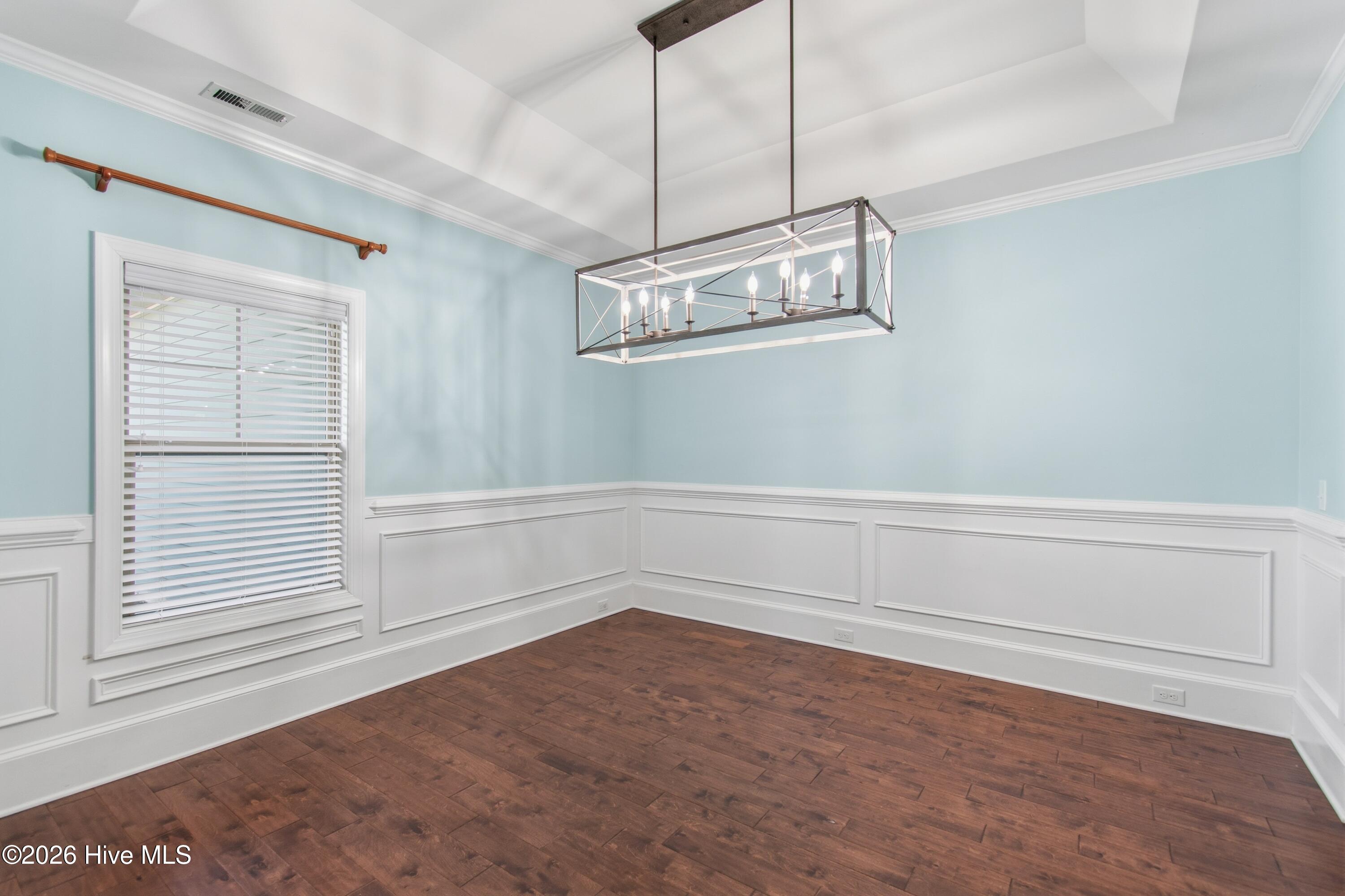 1678 Old Salt Run Southwest Shallotte, NC 28470 - Photo 10 of 73 Dining room with wainscoting and tray ceiling.