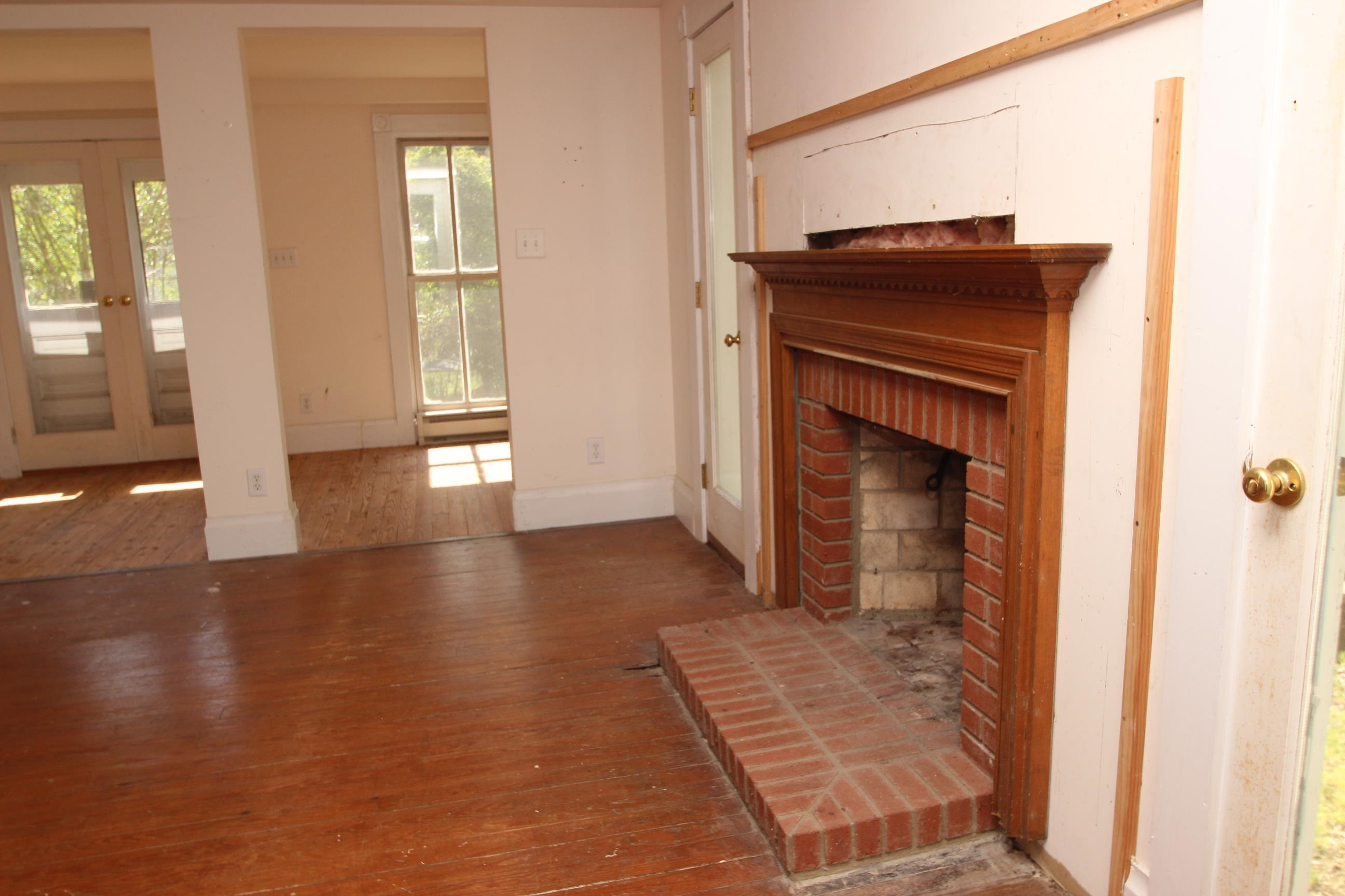 116 Pine Street Carrboro, NC 27510 - Photo 27 of 66 a view of a hallway with wooden floor and a fireplace