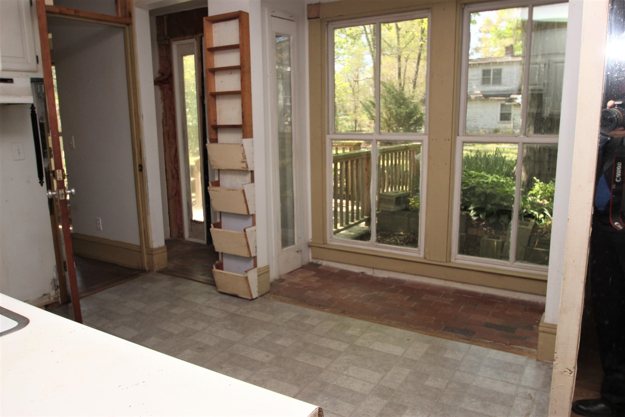 116 Pine Street Carrboro, NC 27510 - Photo 38 of 66 a view of a room that has a large window wooden floor and garden