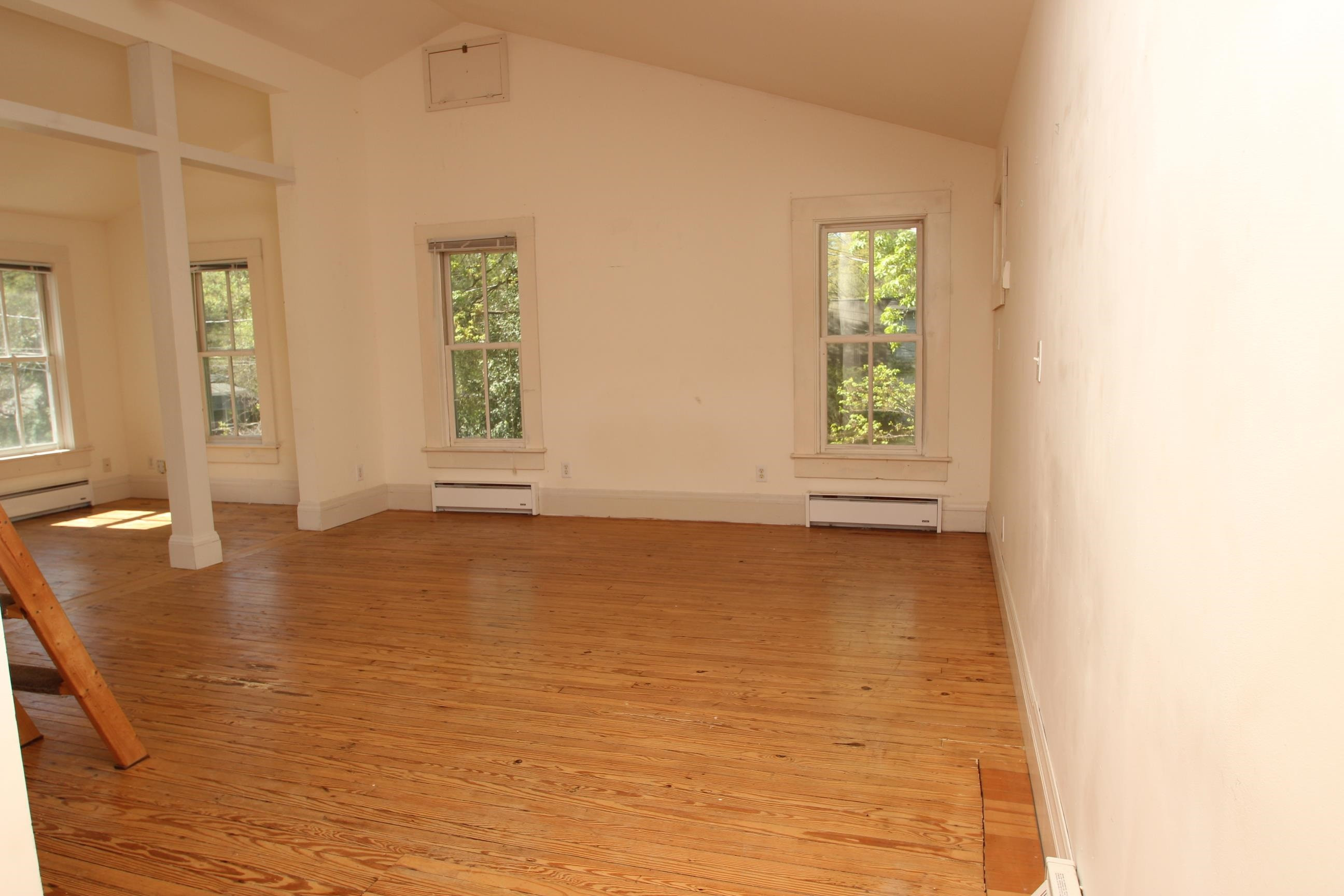 116 Pine Street Carrboro, NC 27510 - Photo 50 of 66 a view of an empty room with wooden floor and a window