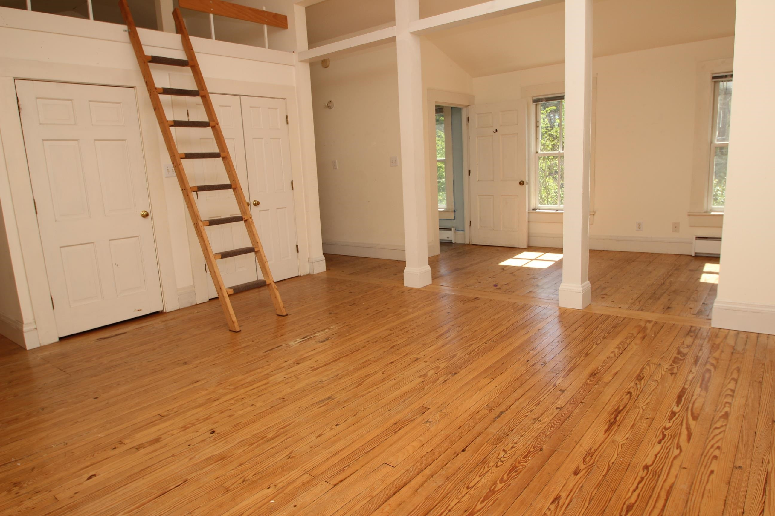 116 Pine Street Carrboro, NC 27510 - Photo 51 of 66 a view of an empty room with wooden floor and stairs