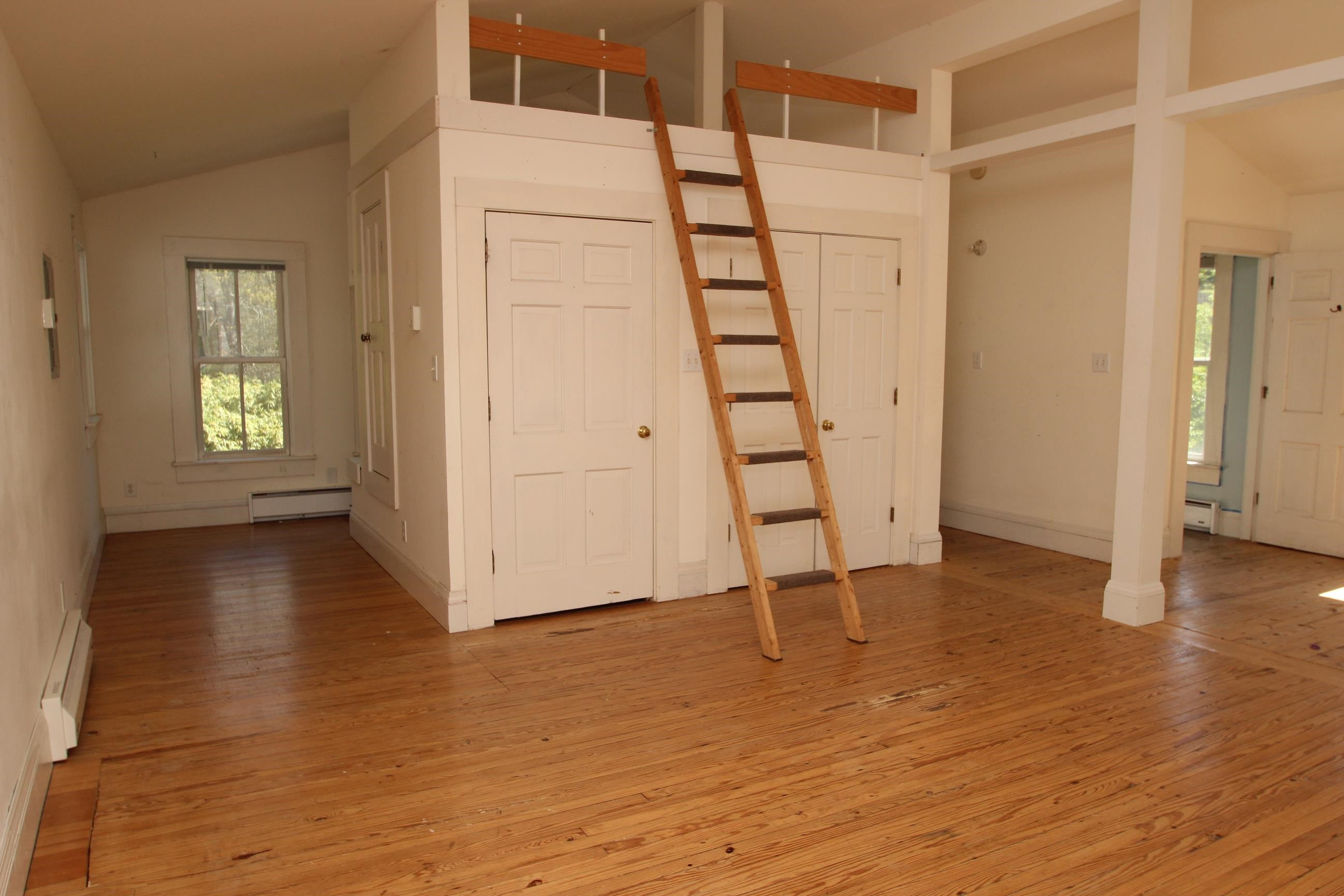 116 Pine Street Carrboro, NC 27510 - Photo 54 of 66 an empty room with wooden floor and windows