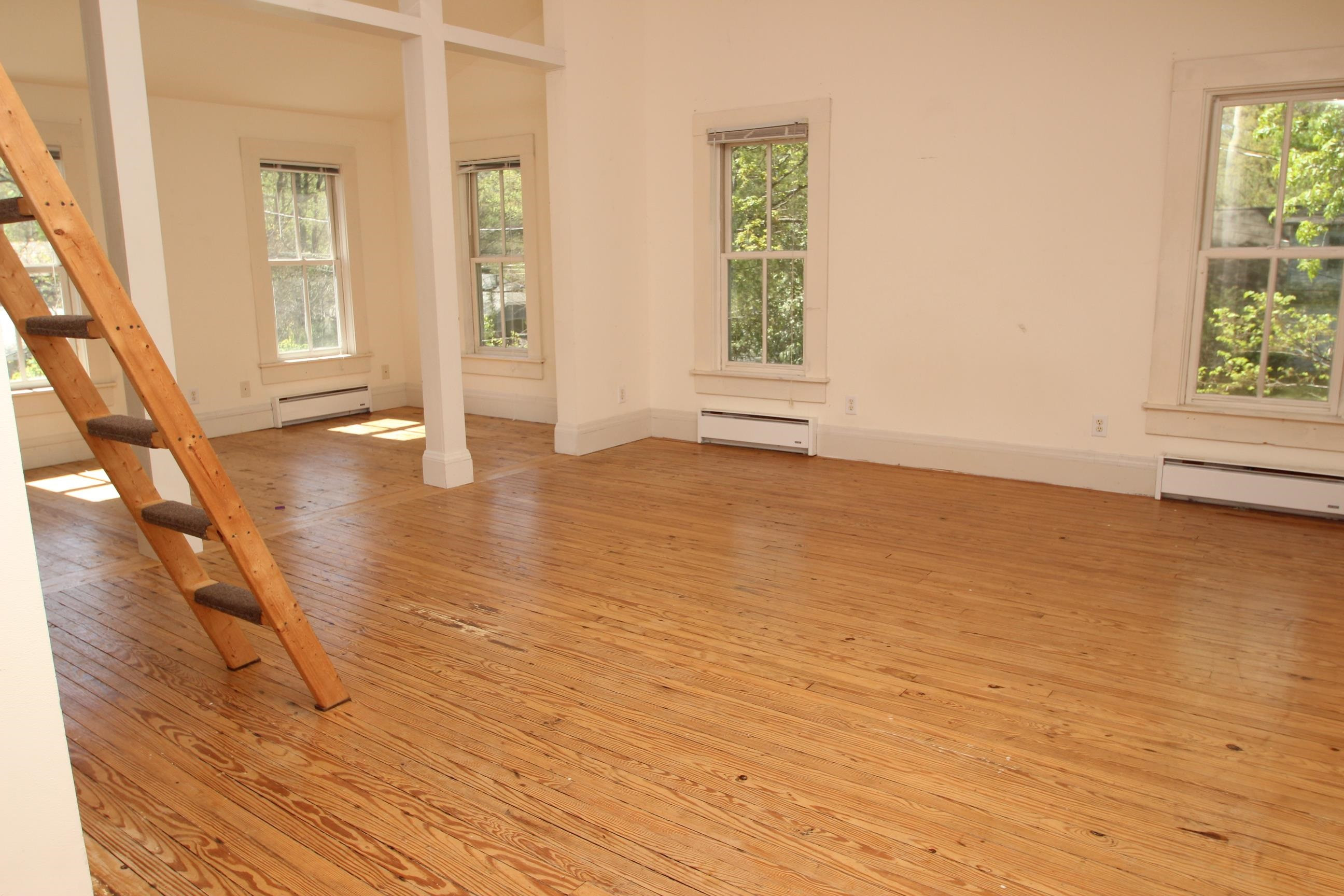 116 Pine Street Carrboro, NC 27510 - Photo 55 of 66 a view of an empty room with wooden floor and a window