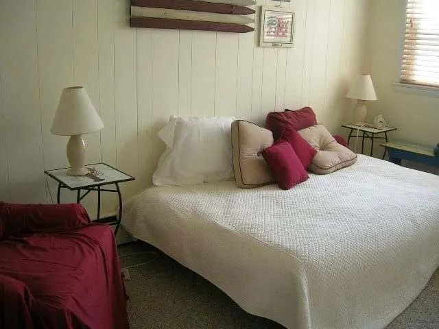 a bedroom with a bed and a lamp