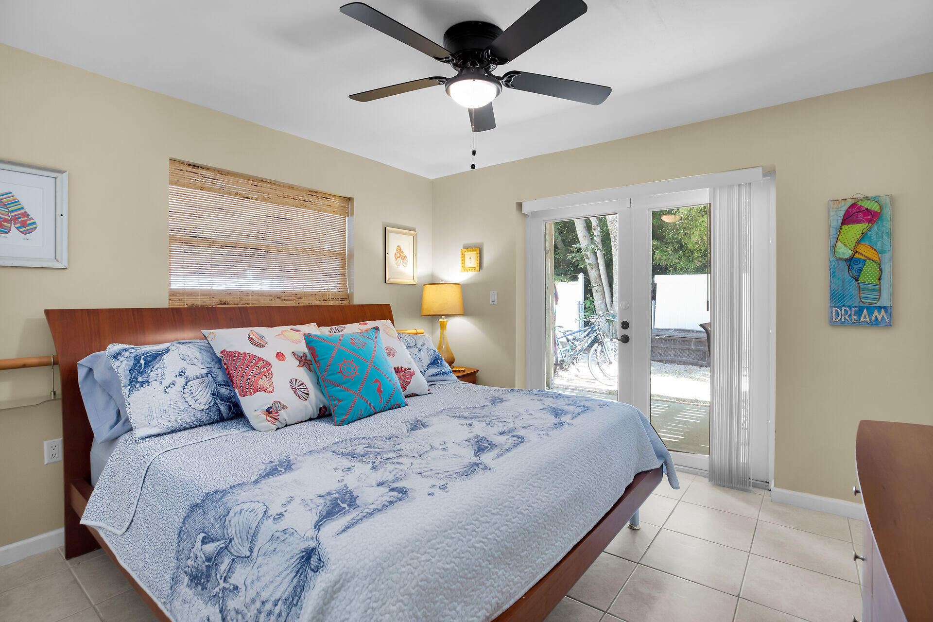 1041 Gibraltar Road Key Largo, FL 33037 - Photo 16 of 36 a bedroom with a bed and a chandelier