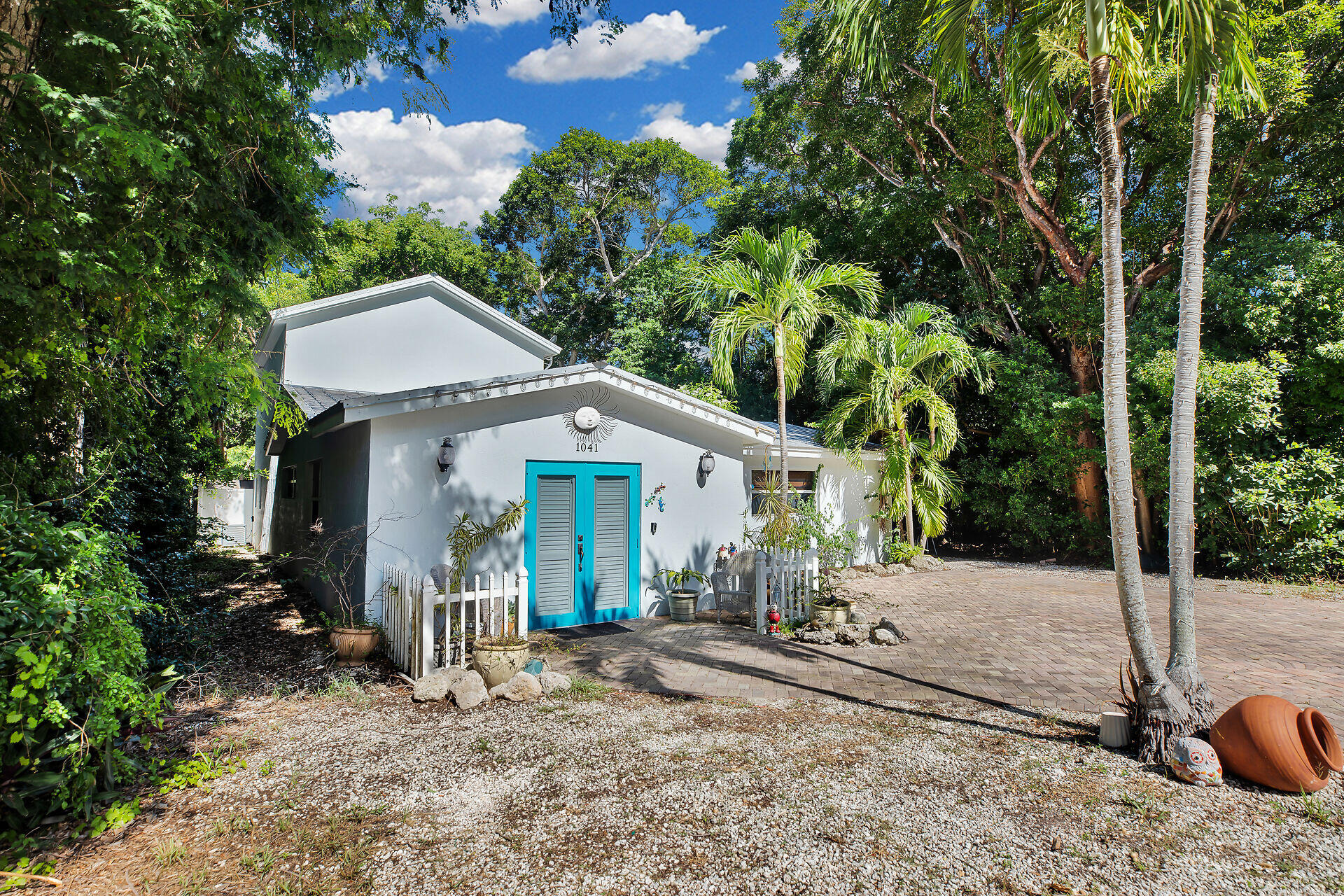 1041 Gibraltar Road Key Largo, FL 33037 - Photo 2 of 36 a front view of a house with garden