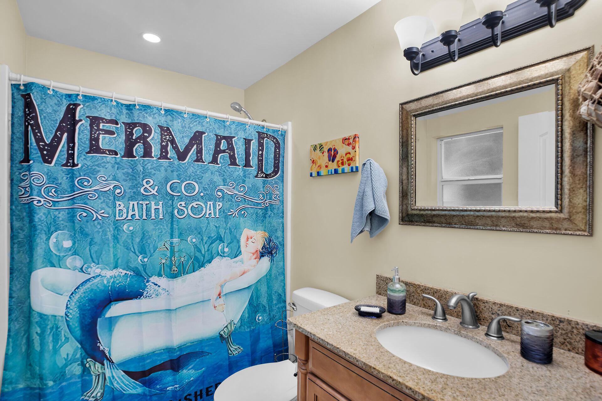 1041 Gibraltar Road Key Largo, FL 33037 - Photo 22 of 36 a bathroom with a toilet a sink and a mirror