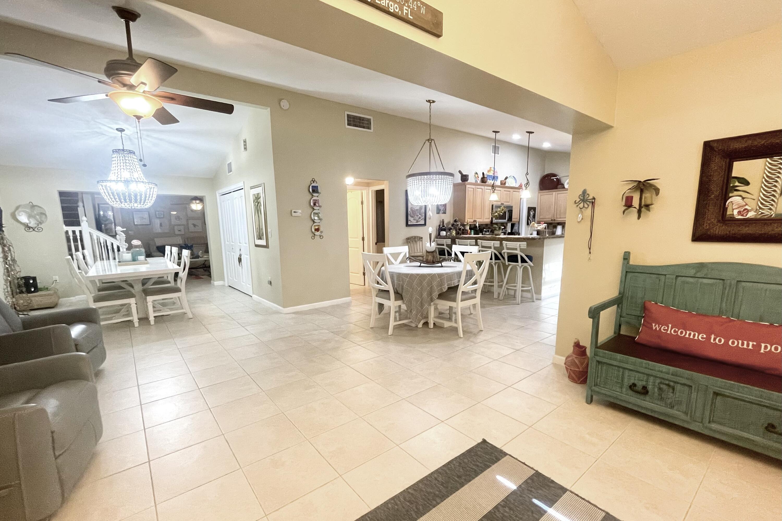 1041 Gibraltar Road Key Largo, FL 33037 - Photo 3 of 36 a living room with lots of furniture and a chandelier
