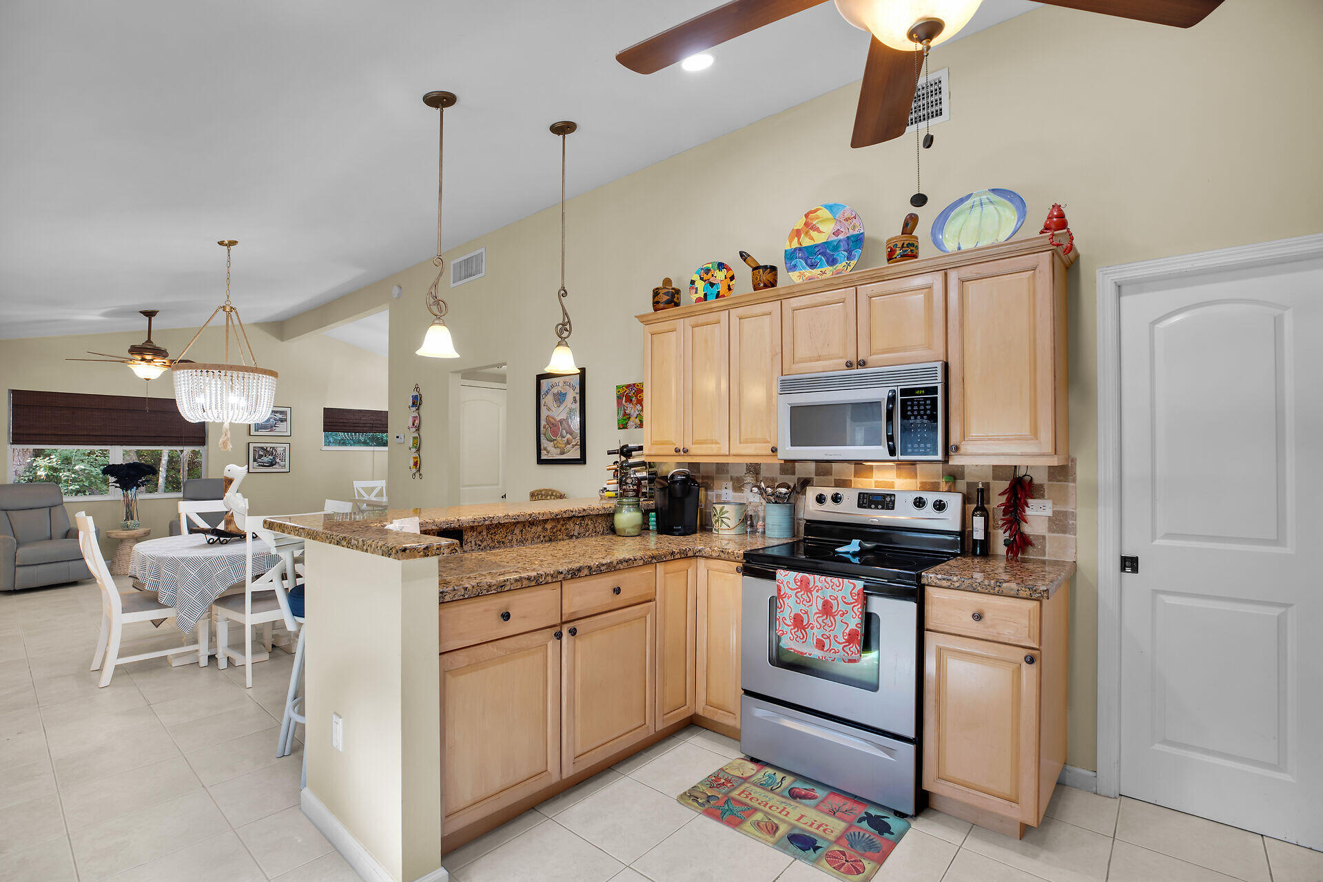 1041 Gibraltar Road Key Largo, FL 33037 - Photo 8 of 36 a kitchen with appliances a sink and cabinets