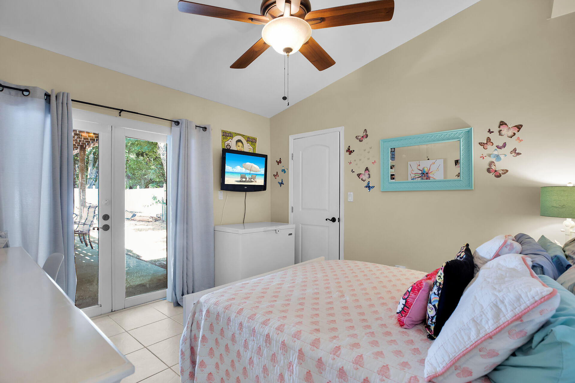 1041 Gibraltar Road Key Largo, FL 33037 - Photo 10 of 36 a bedroom with a large bed and a chandelier